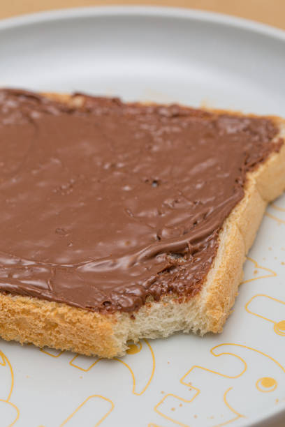 istock Chocolate sauce melted over a bread slice on a white plate 1171349990