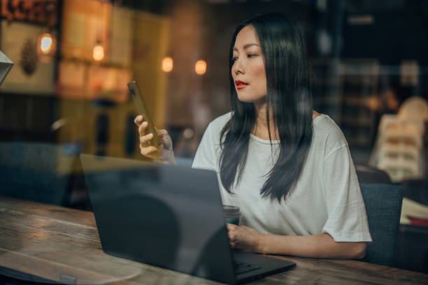 Young woman working on laptop in cafe