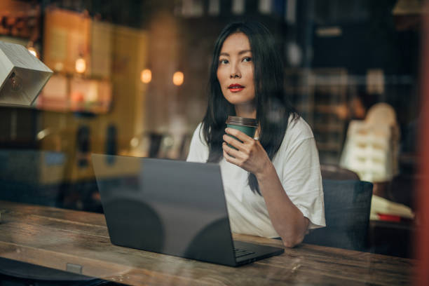 istock Young woman working on laptop in cafe 1171350723
