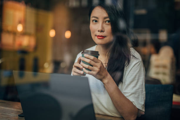 istock Young woman working on laptop in cafe 1171350738