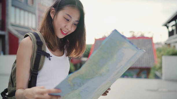 istock Cheerful beautiful young Asian backpacker woman direction and looking on location map while traveling at Chinatown in Beijing, China. Lifestyle backpack tourist travel holiday concept. 1171351505