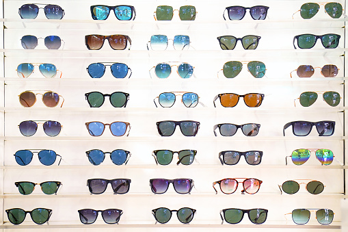 Stand with sunglasses. Sale the city market or in the store sunglasses. Trendy sunglasses, Summer eyeglasses, fashion collection, Different sunglasses on a stand.