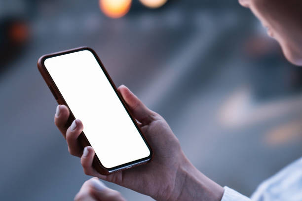 istock Woman's hands holding mobile phone with lighted big copy space touch screen outdoors with evening bokeh light of city. Close up view of female person using smartphone app for online shopping 1171354463