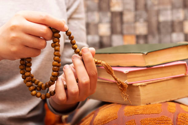 istock Muslim women using misbaha to keep track of counting in tasbih 1171358577