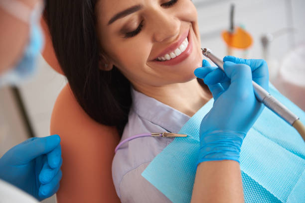 istock Smiling lady with closed eyes having dental procedure 1171363548