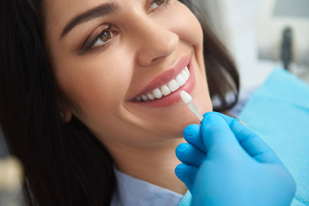 istock Dentist is holding teeth model near female mouth 1171363564