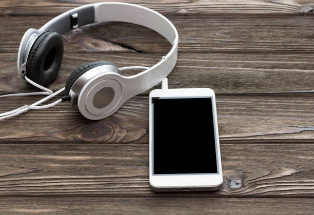 istock headphones, smartphone on a wooden 1171364098