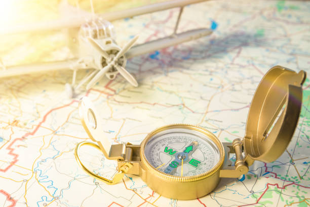 istock travel concept. vintage compass on a map and plane in the background. 1171364681