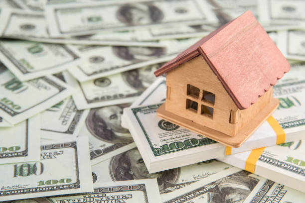 istock House on a bundle of dollar money. 1171364689