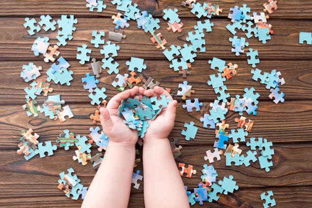 istock puzzles in the hands of a child. puzzles 1171364692