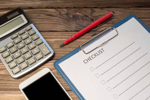 istock check sheet form, calculator, smartphone on a wooden background. 1171364913