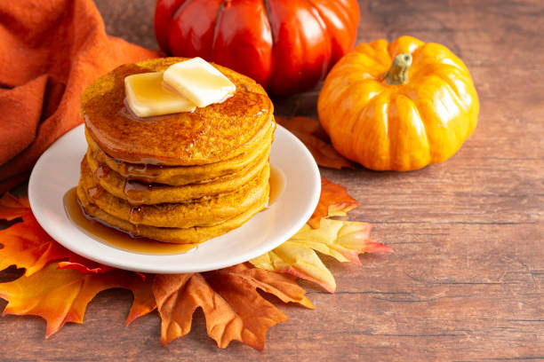 A Stack of Pumpkin Spice Flavored Pancakes on a Wooden Table A Stack of Pumpkin Spice Flavored Pancakes on a Wooden Table pancake stock pictures, royalty-free photos & images