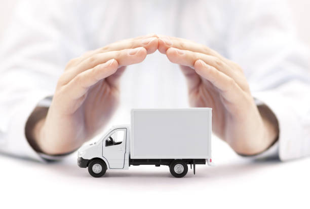 istock Cargo delivery truck protected by hands 1171367448