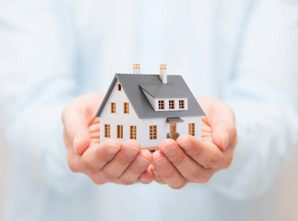istock Small toy house in hands 1171367481