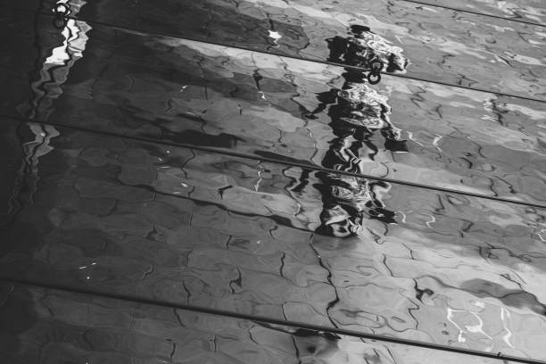 istock Distorted reflection and shadow of pedestrians on the ceiling of a canopy 1171368438