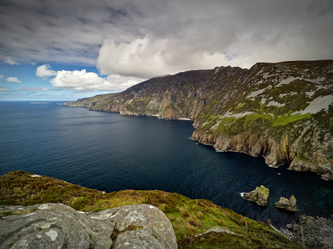 View from the cliffs of Slieve League, Co. Donegal across a small bay out to the Atlantic Ocean with the famous Giant's Chair and Table in the foreground. The cliffs measure up to 601 m and are among the highest sea cliffs in Europe.