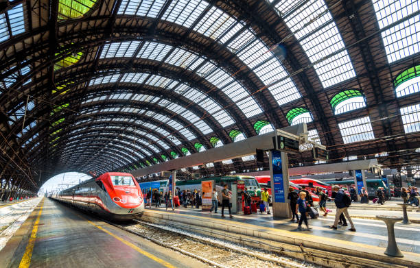 people and high-speed trains at the railway milan central station - travel passenger milan italy italy imagens e fotografias de stock