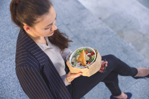 istock Office worker eating salad outdoor. Top view 1171374795