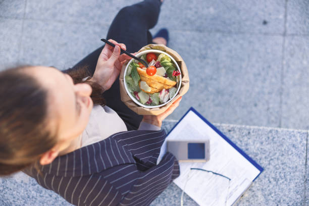istock Office worker eating salad outdoor. Top view 1171376283