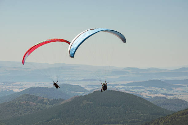 Tandem paragliders thermalling in Puy de Dome, Auvergne, French Massif Central. France stock photo