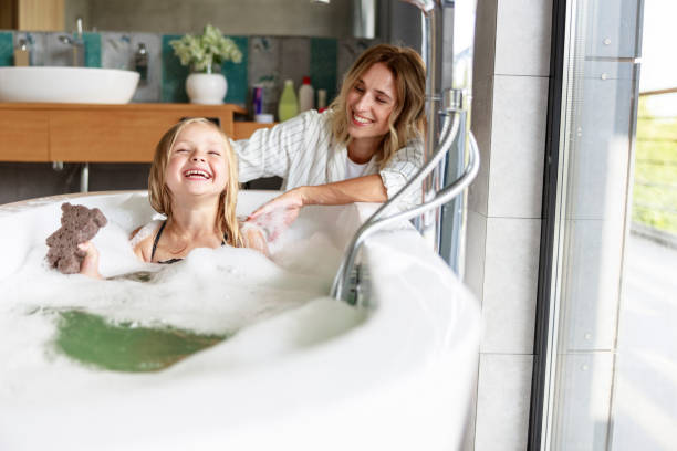 istock Mother and daughter have fun in the bath 1171380437