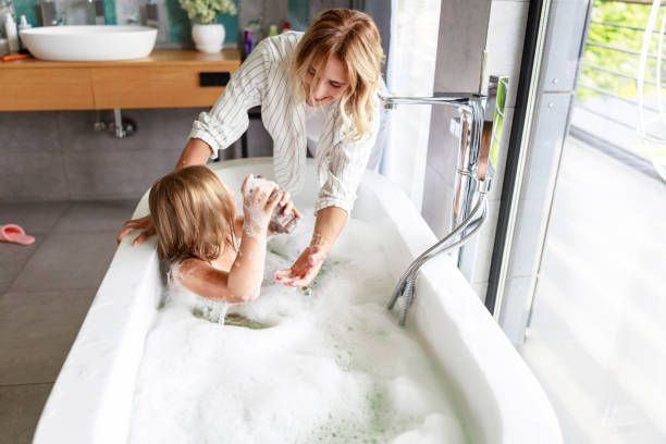 istock Mom and daughter looking at each other in bathroom 1171380443