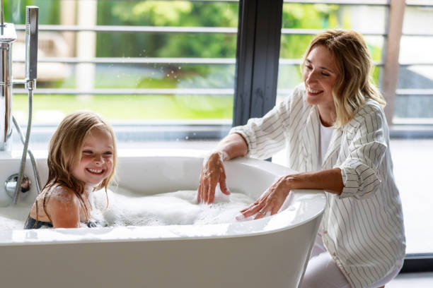 istock Cute girl is having a fun in bath 1171380461