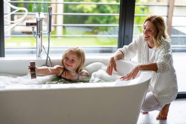 istock Happy cute girl with bath sponge in bath 1171380972