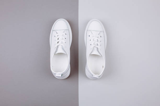 istock White sneakers on a gray background. 1171392397