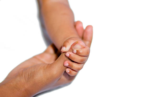 istock A asian baby's hand holding her mother finger 1171393191