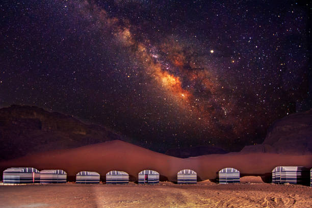 a camp in wadi rum desert at night with milky way, jordan. - leito de rio imagens e fotografias de stock