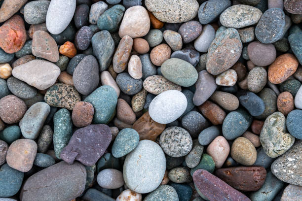 istock Close up of rounded and polished beach rocks. 1171395159