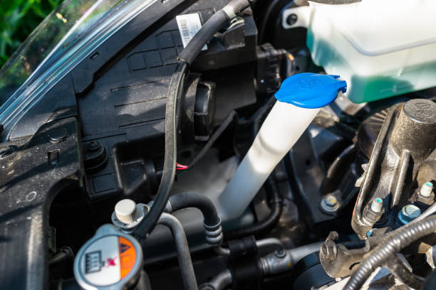 istock Windshield washer fluid reservoir with blue stopper, located in the engine compartment. 1171395766