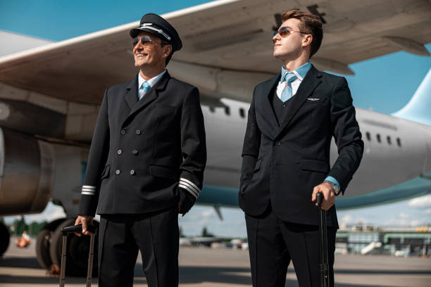 istock Caucasian smiling pilots are ready for flight in airport 1171400311