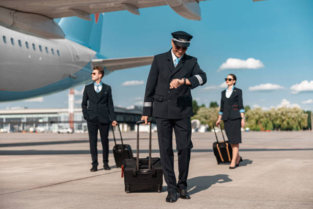 istock Smiling Caucasian pilot looking at watch in airport 1171400400