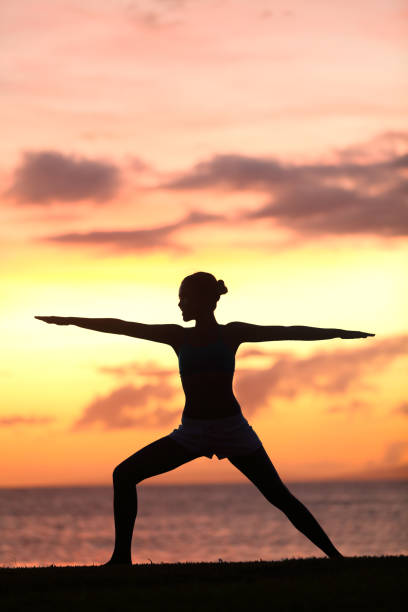 istock Yoga woman training and meditating in warrior pose 1171401310