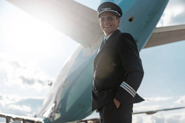 istock Handsome pilot in sunglasses standing near airplane 1171402147