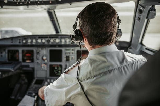 istock Caucasian mature man in uniform piloting modern airplane 1171402212