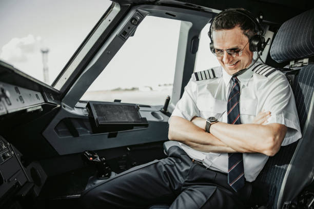 istock Caucasian smiling man in uniform looking at watch 1171402227