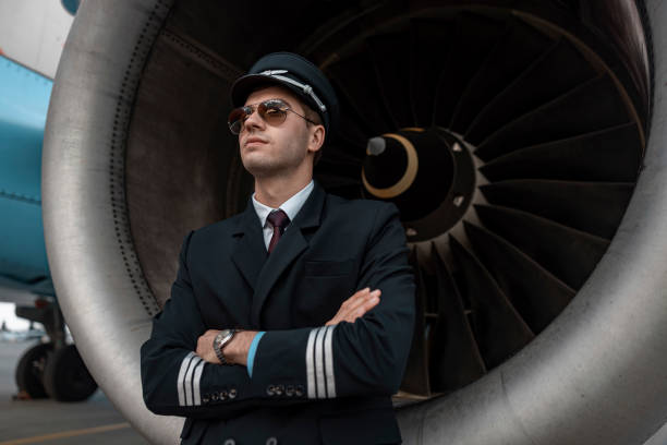istock Serious young man standing near engine of airplane 1171402305
