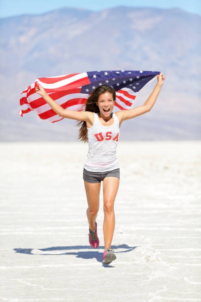 istock Athlete woman with american flag running 1171406149