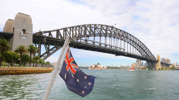 sydney harbor bridge with australian flag - darling harbor imagens e fotografias de stock