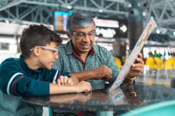istock Grandfather with his grandson choosing snack from the menu 1171407956
