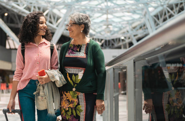 Grandmother and her granddaughter waiting for the flight time at the airport Family, Grandmother, Airport, Travel Destinations, Arrival mall walker stock pictures, royalty-free photos & images