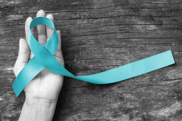 istock Turquoise or Robin egg blue ribbon on human hand old aged background raising awareness on Bone tumor, Addiction recovery and Pierre Robin syndrome 1171414965