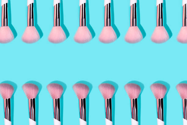 istock Pattern made of make up white brush on turquoise background. 1171416147