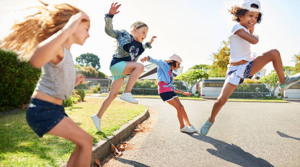 istock Kids playing and jumping outdoors 1171422968
