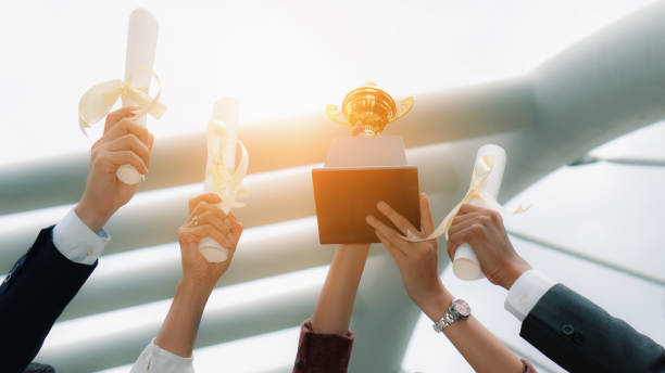 istock hands holding trophy and certificate recieved award winning from business campiagn contest 1171425607