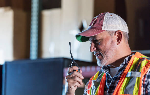 istock Hispanic man standing in warehouse on walkie-talkie 1171425826