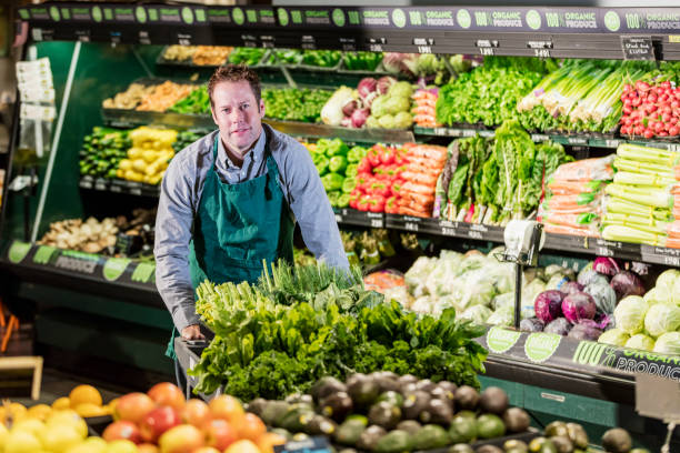 istock Man working in supermarket produce aisle 1171427333